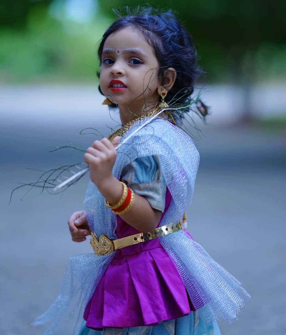 Little girl in bespoke festive half-saree with gold waist belt and sheer dupatta by Harsa Boutique