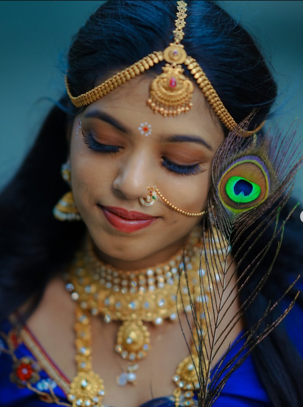 South Indian bride in royal blue silk blouse adorned with fine gold zari and stone work
