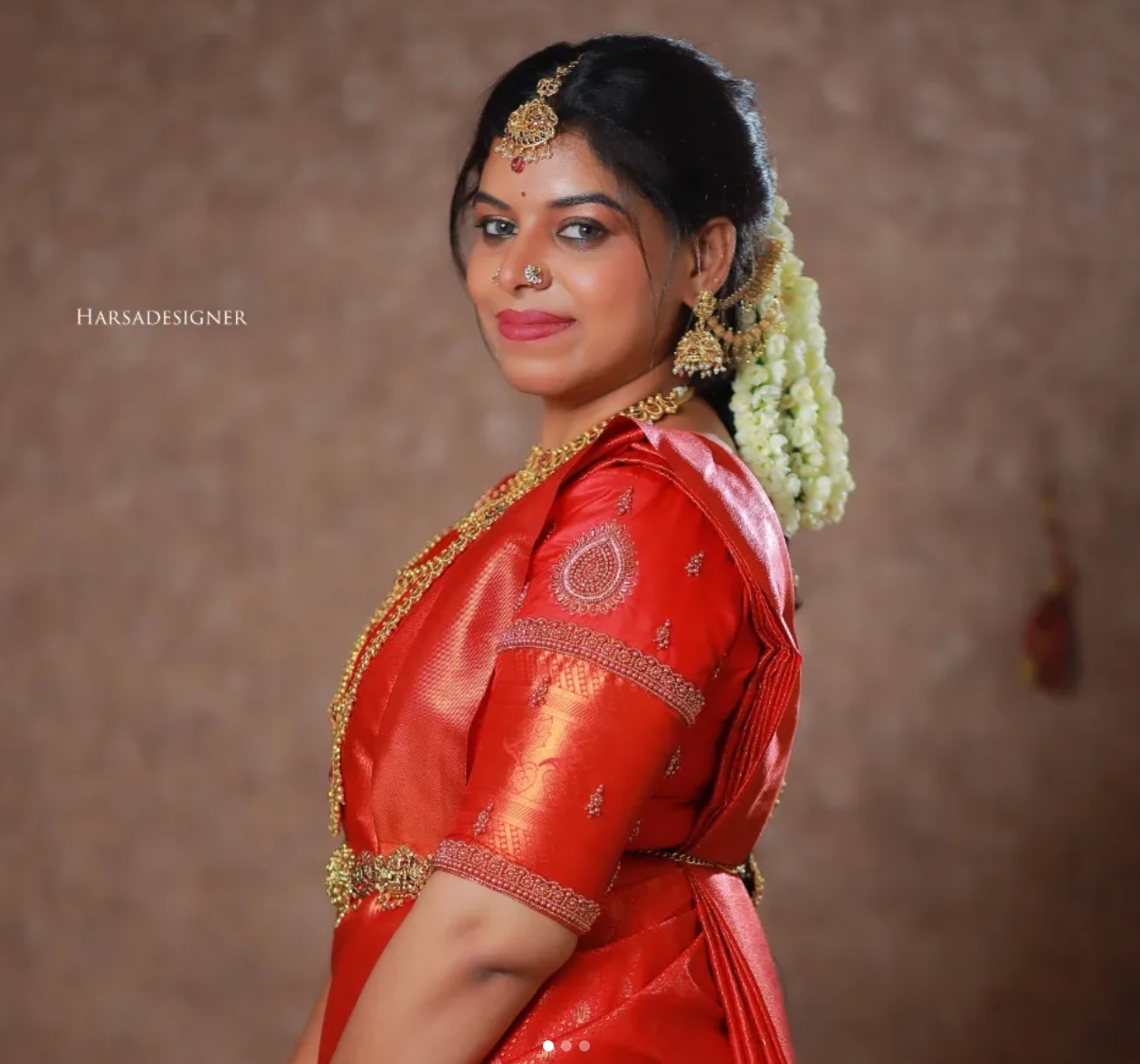 Harsa Designer authentic watermark portrait of bride in crimson red silk saree with teardrop paisley motif Aari sleeve