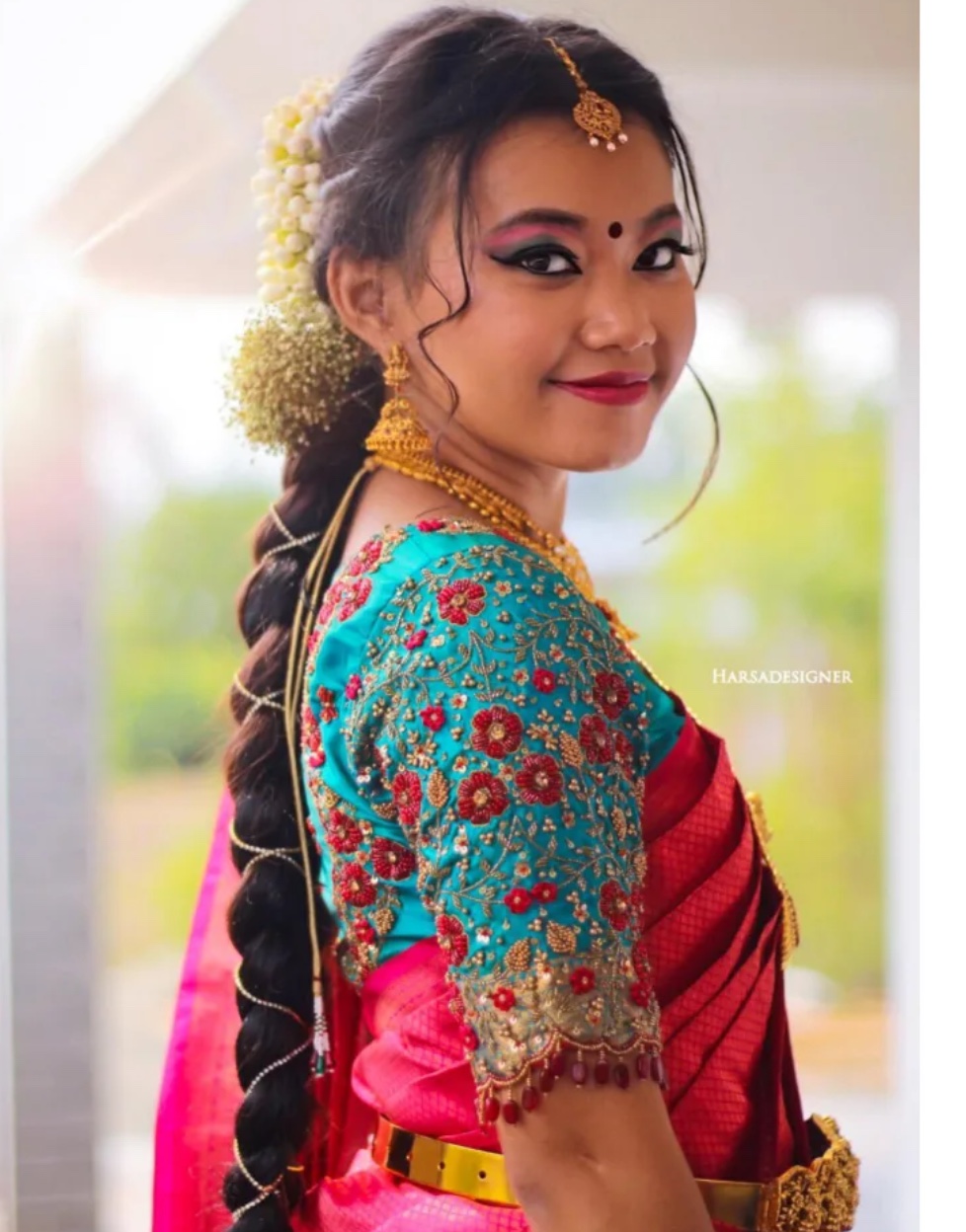 Cyan blue bridal blouse with floral embroidery and scalloped bead hangings by Harsa Designer Boutique